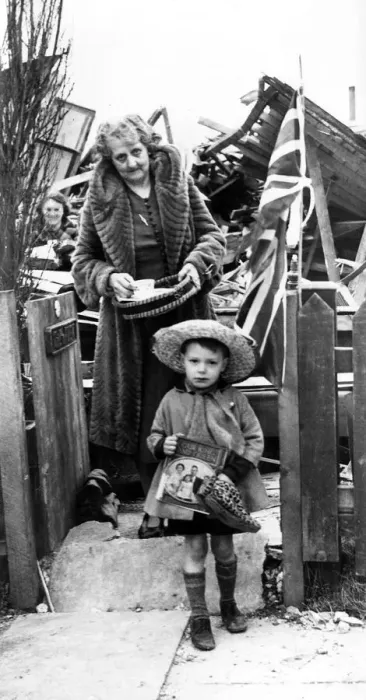 Framed Print : During the second world war, a little boy stands outside the shambles of his bombed home