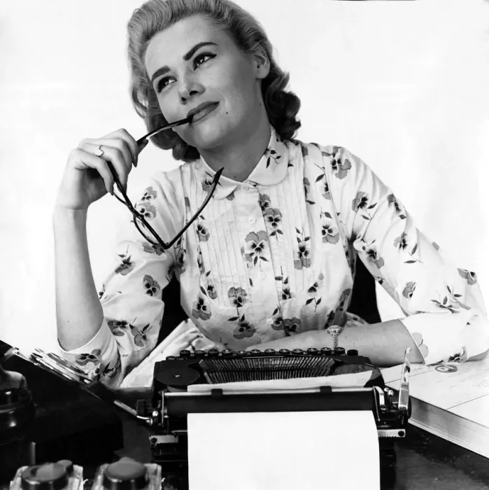 Framed Print : Secretary at typewriter chewing the end of her glasses daydreaming Typist Framed Print : Secretary at typewriter chewing the end of her glasses daydreaming Typist