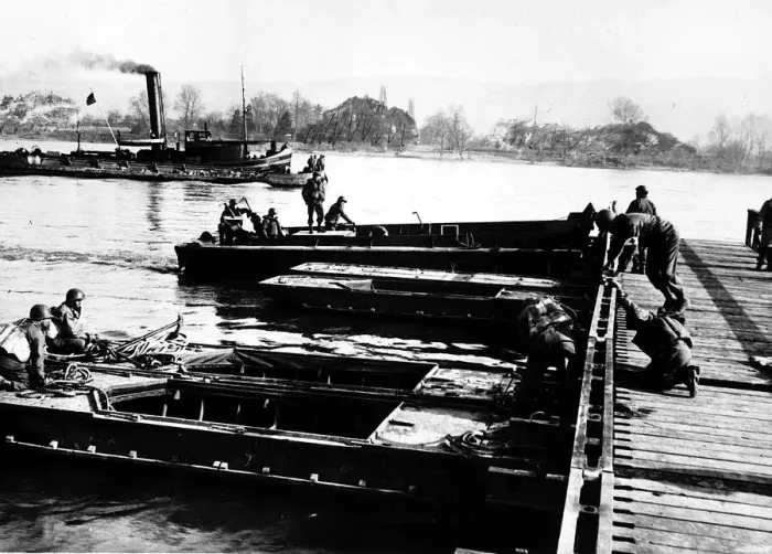 Framed Print : Section of army treadway bridge is pushed into place by landing craft personnel Framed Print : Section of army treadway bridge is pushed into place by landing craft personnel