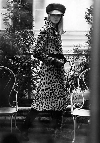 Seen behind bars, a mannequin modeling a leopard skin fur coat. July 1967 P006368