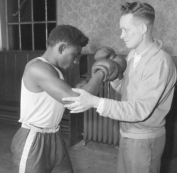 Senior trainer Bill Davies show a 19 year old West Indian, Randolph Bottley