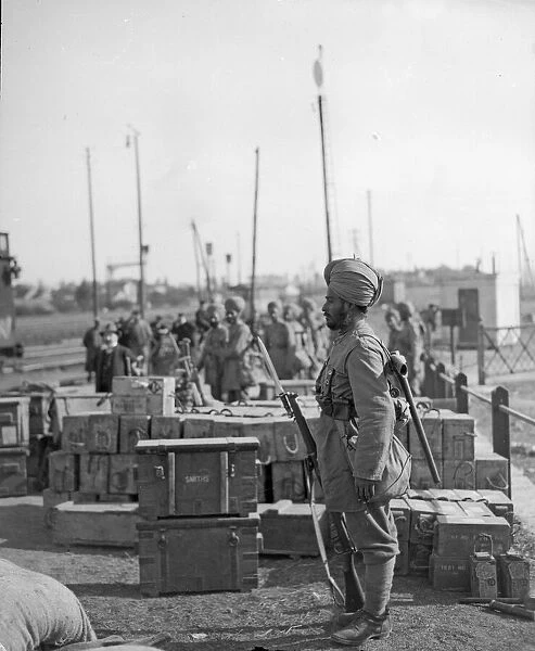 Sentry from the 3rd Lahore Indian Division seen here guarding ammunition boxes at their
