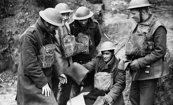A sergeant of the British Expeditionary Force hands out some home knitted scarves to his