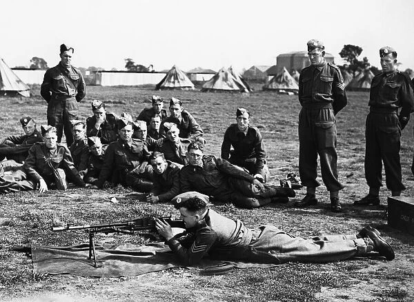 A Sergeant instructor demonstrating to recruits the working of a Bren-Gun