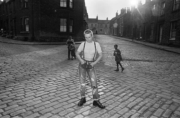 Seventeen year old skinhead teenager Janet Askham poses in the street at her home in