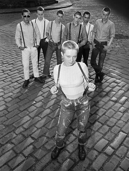Seventeen year old skinhead teenager Janet Askham poses with her friends at her home in