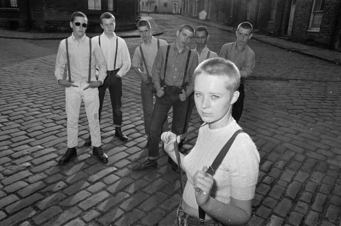 Framed Print : Seventeen year old skinhead teenager Janet Askham poses with her friends at her home in