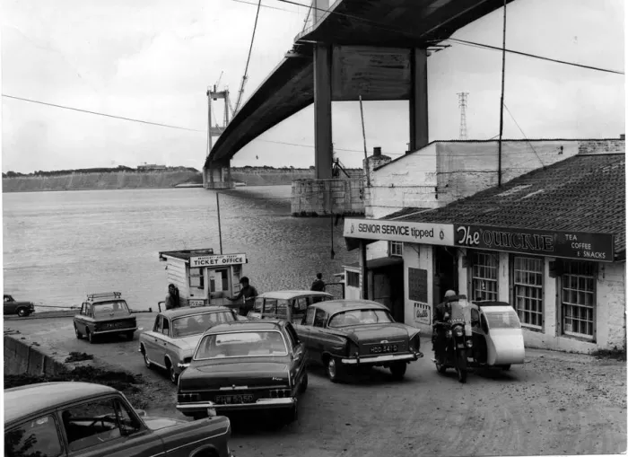 Framed Print : Severn Ferry - Cars queue up for the ferry with the recently completed bridge towering Framed Print : Severn Ferry - Cars queue up for the ferry with the recently completed bridge towering