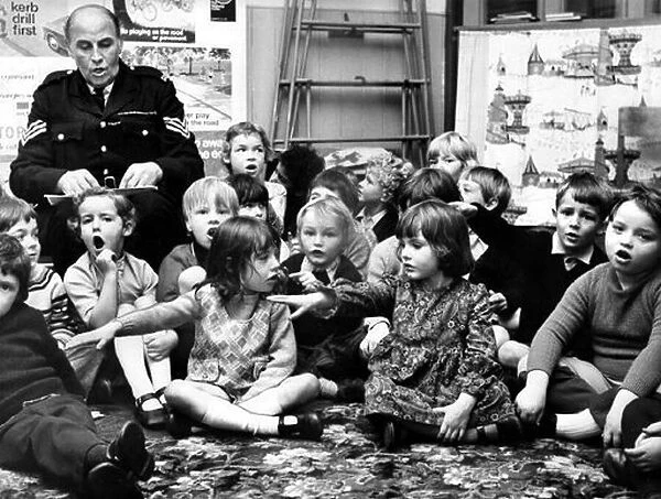 Sgt Noel Knox, is pictured with children at spital Tongues infants school in 1972