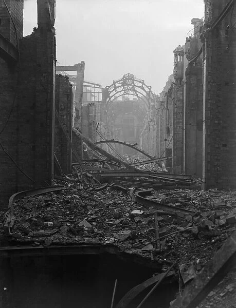 The shattered remains of The Arcade, High Street, Birmingham still smoulders the morning