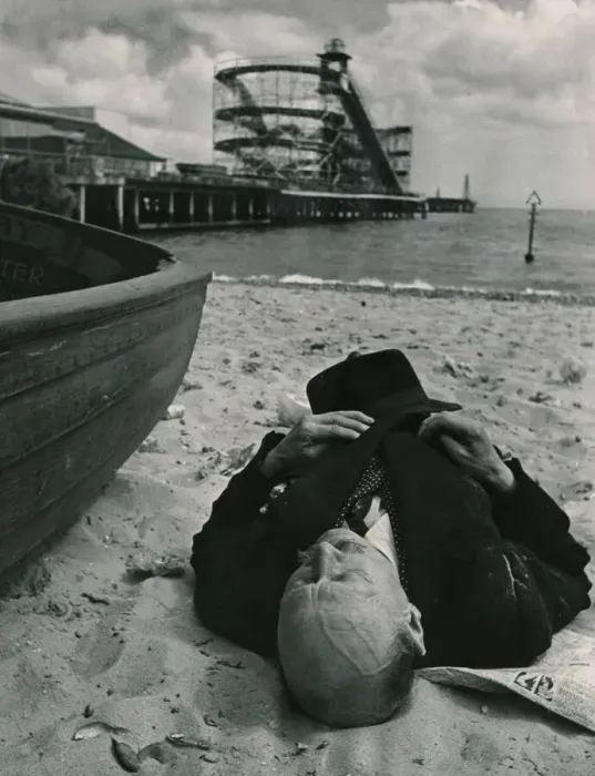 Framed Print : Sheltered from the squalls in the Whitsun sunshine this holiday maker sleeps on the beach