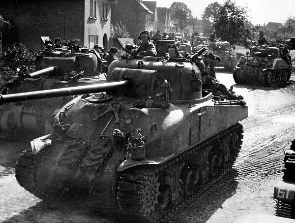 A Sherman Firefly 1C Tank of the 11th Armoured Division leads a column of tanks through