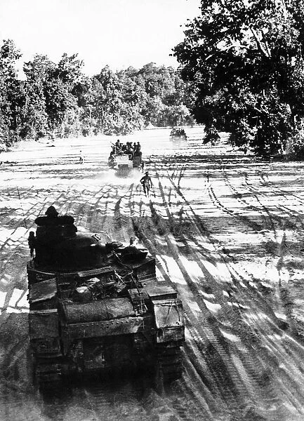 Sherman and Lee tanks make their way along the dried up river bed of the Sipadon Chaung