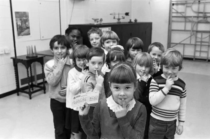 Framed Print : Shhh... says five-year-old Emily Fozzard as she hands over this £ Framed Print : Shhh... says five-year-old Emily Fozzard as she hands over this £