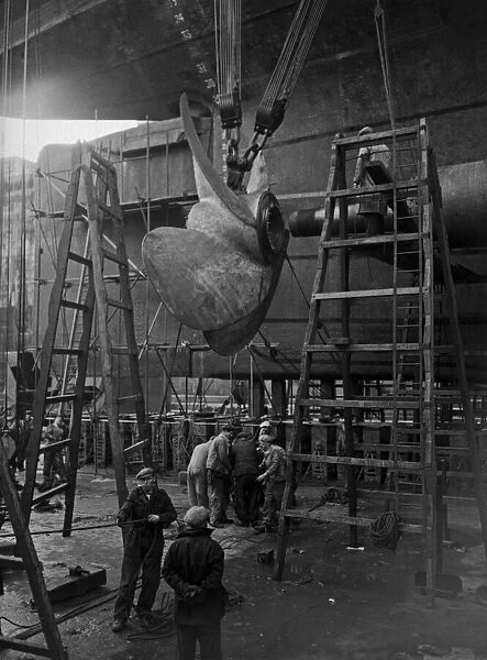Shipbuilders at the King George V dry dock in Southampton replace one of the mighty