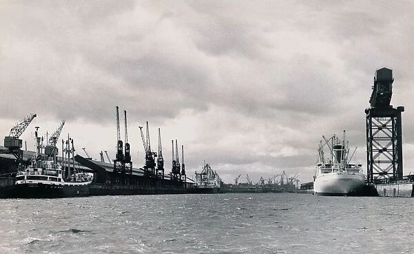 A shipping dock yard with cranes, and already docked are The New Zealand Star London