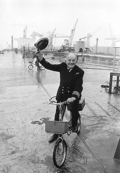 Ships Captain Tom Agnew Captain Agnew with his bike on the deck of the massive Esso