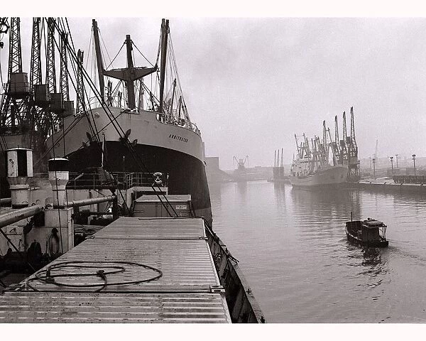 Ships unloading in the docks at Manchester seen through the mist May 1967
