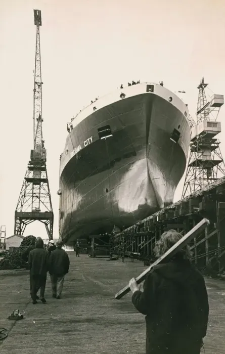 Framed Print : Shipyard Workers watch the launch of the Tocoma City as the new liner glides from her Framed Print : Shipyard Workers watch the launch of the Tocoma City as the new liner glides from her