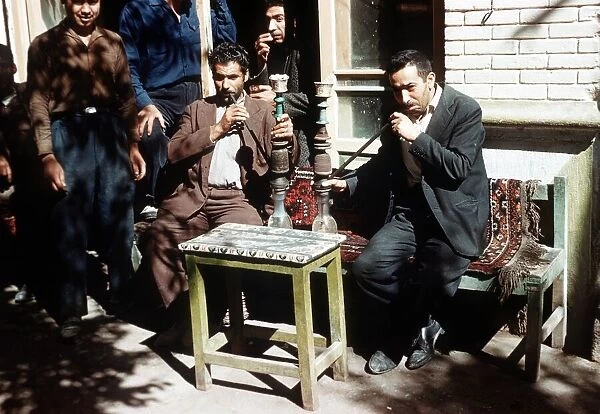 Shiraz South West Iran Persians smoking hubble bubble pipes at a cafe