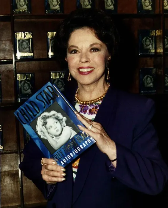Framed Print : Shirley Temple actress holding up a copy of her book Child Star May 1989