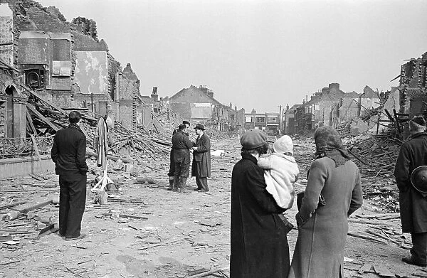 Shocked Londeners survey the destruction on their street, 19th March 1941