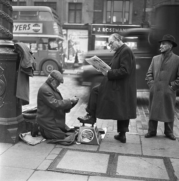 Shoe shine at work in Whitechapel High Street in the east end of London