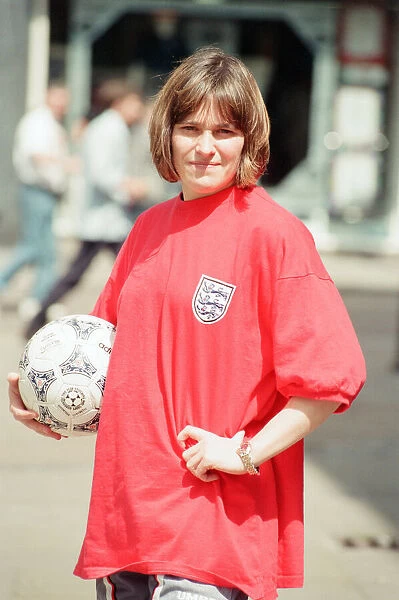 Shop asistant Karen Burke from Soccer City, models Englands old Red Strip, Liverpool