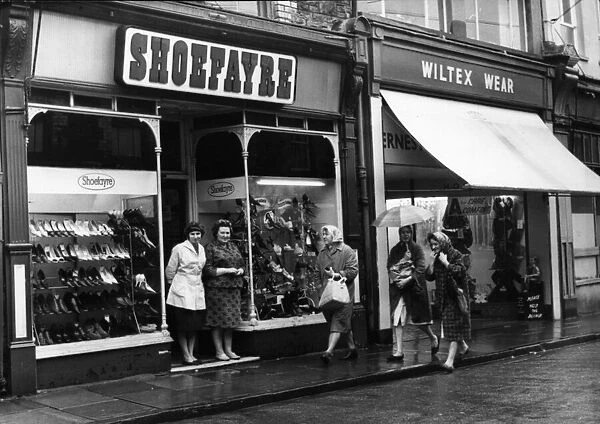 Shoppers brave the rain in Hannah Street, Porth November 1964