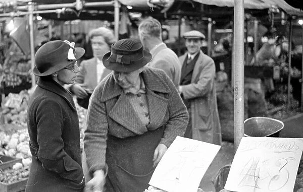 Shoppers at the green grocers stall in Kingston Market. Circa 1936