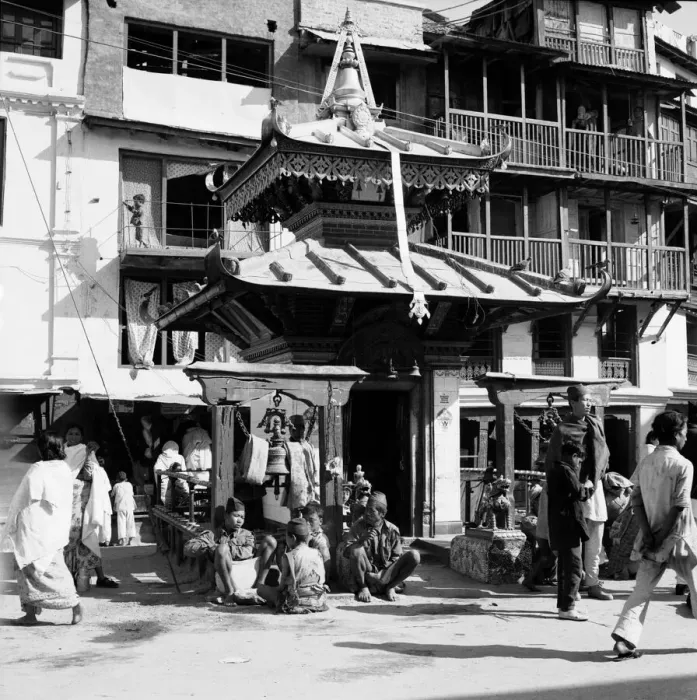 Framed Print : Shoppers pass a shrine to Buddah in one of the main roads leading off Durbar Square in Framed Print : Shoppers pass a shrine to Buddah in one of the main roads leading off Durbar Square in