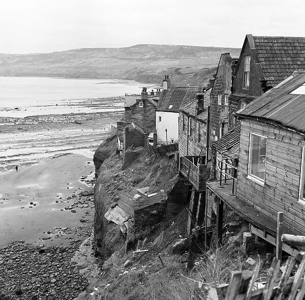 Shored up houses on the cliffs at Robin Hoods Bay, North Yorkshire. 3rd March 1970