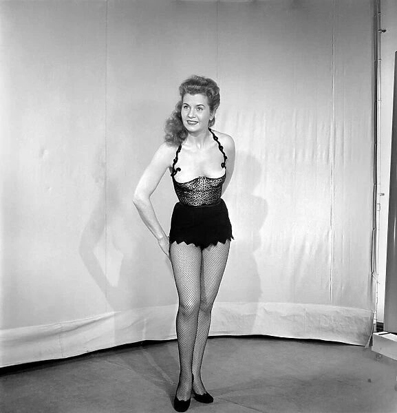 Showgirl in costume holding sword. 1959 E62-002