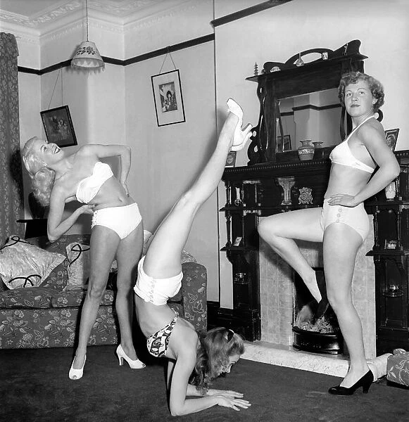 Three showgirls limber up in their digs before a performance. 1959 E09-004