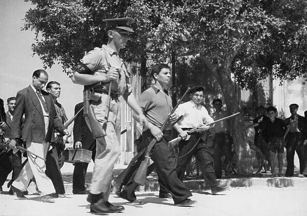 Sicilian civilians hand over arms to British soldiers. 17th August 1943