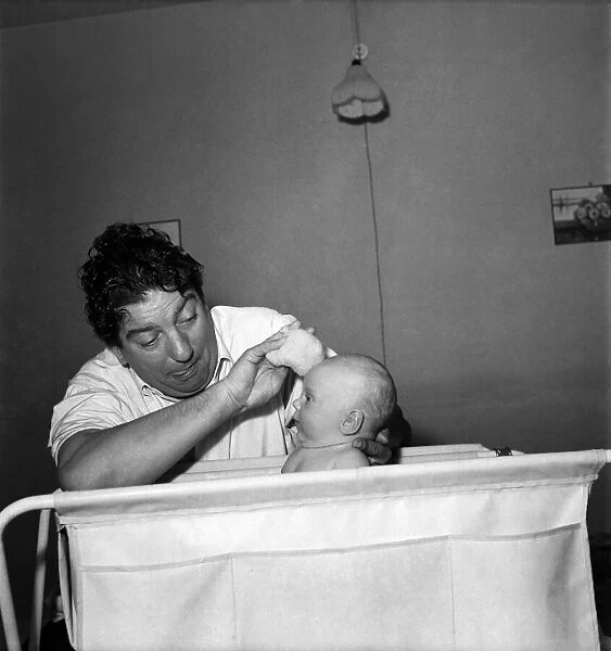 Sid Field with baby. September 1948 O14844-002