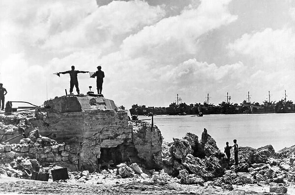 US Signalman directs landing ships off Okinawa Beach. A US Navy Signalman