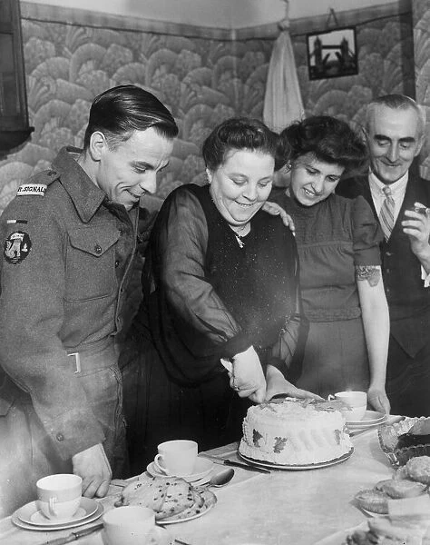 Signalman in the Royal Navy Andrew Cambpell about to eat a cake made for him by his