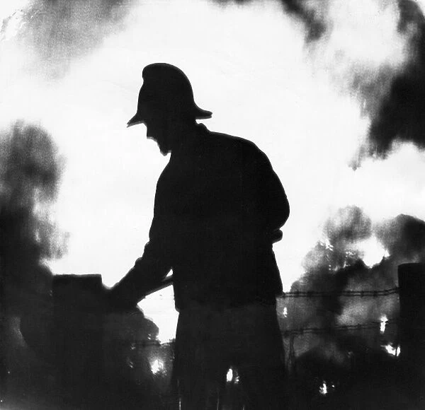 A silhouette of fireman fighting the blaze