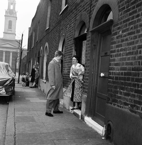 Singer and actor Tommy Steele says goodbye to his mother outside their home in Bermondsey