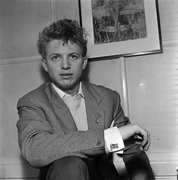 Singer and actor Tommy Steele showing of this Rock n Roll cufflinks