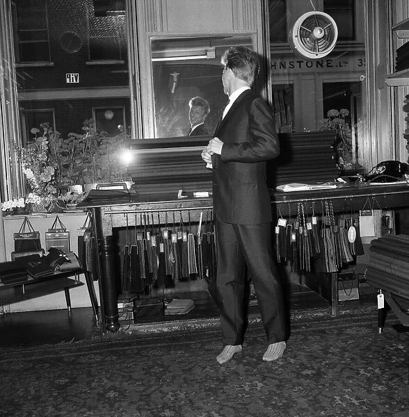 Singer and Actor Tommy Steele tries on his wedding suit. 1960