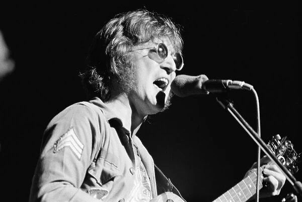 Former singer of The Beatles pop group John Lennon pictured performing on stage during