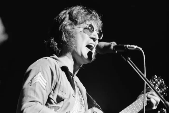 Framed Print : Former singer of The Beatles pop group John Lennon pictured performing on stage during