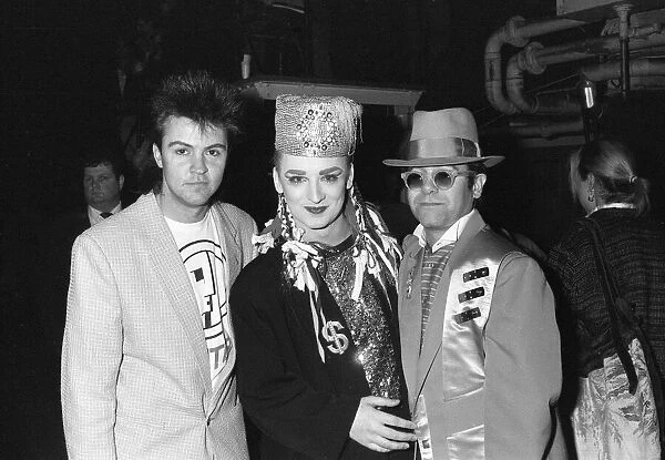 Singer Boy George poses with Paul Young (left) and Elton John (right