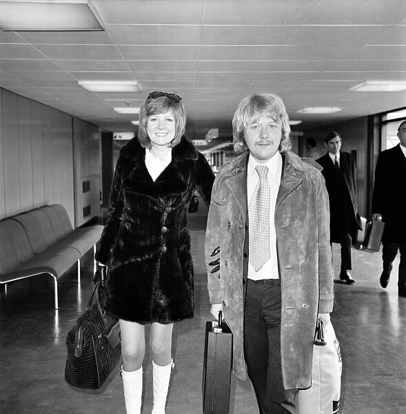 Singer Cilla Black pictured at Heathrow airport with her husband Bobby