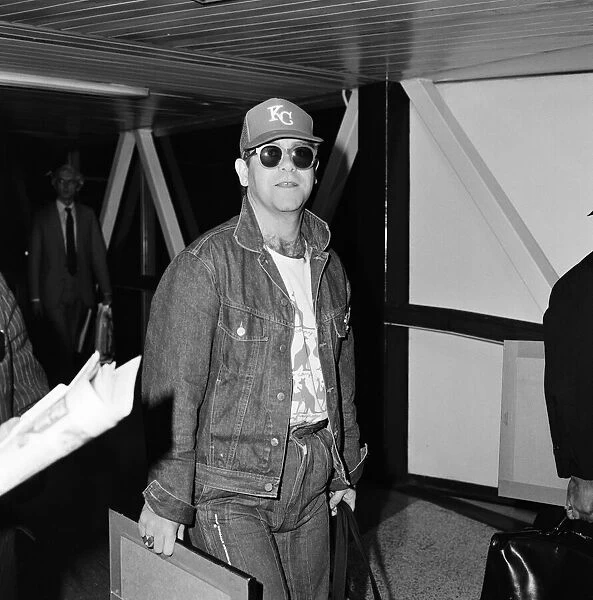 Singer Elton John, arrives at Heathrow airport from Australia