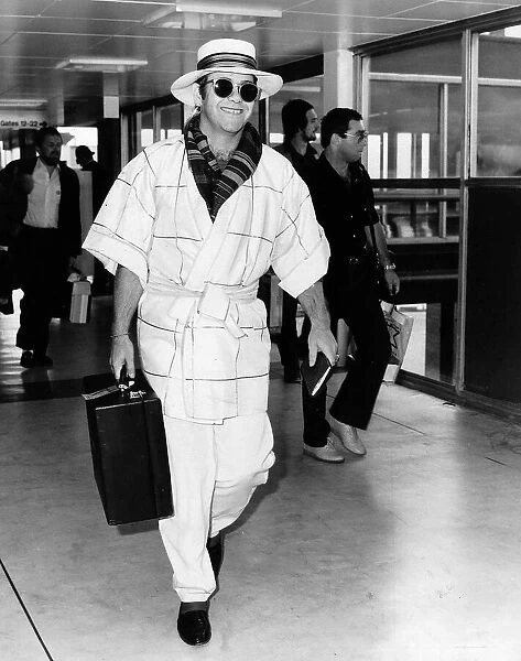 Singer Elton John pictured at Heathrow airport. 11th April 1982