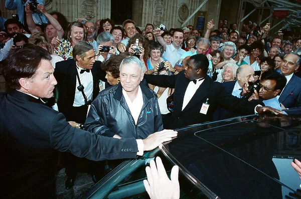 Singer Frank Sinarta is mobbed by waiting fans as he arrives at the Royal Albert Hall to
