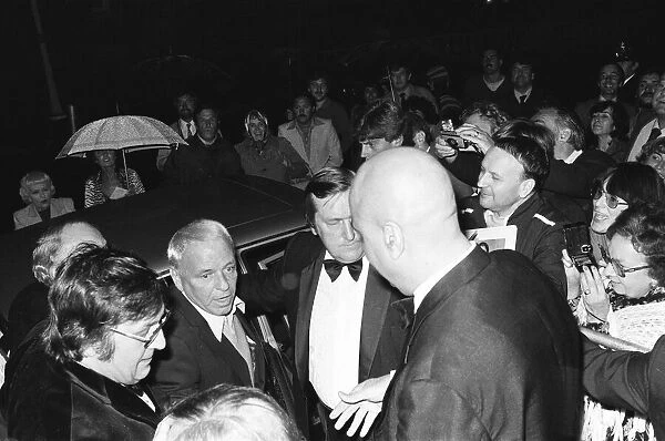 Singer Frank Sinatra is mobbed by waiting fans as he arrives at the Royal Albert Hall